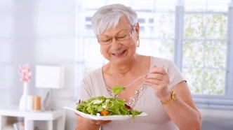 senior woman eating healthy food 1200x600 crop center